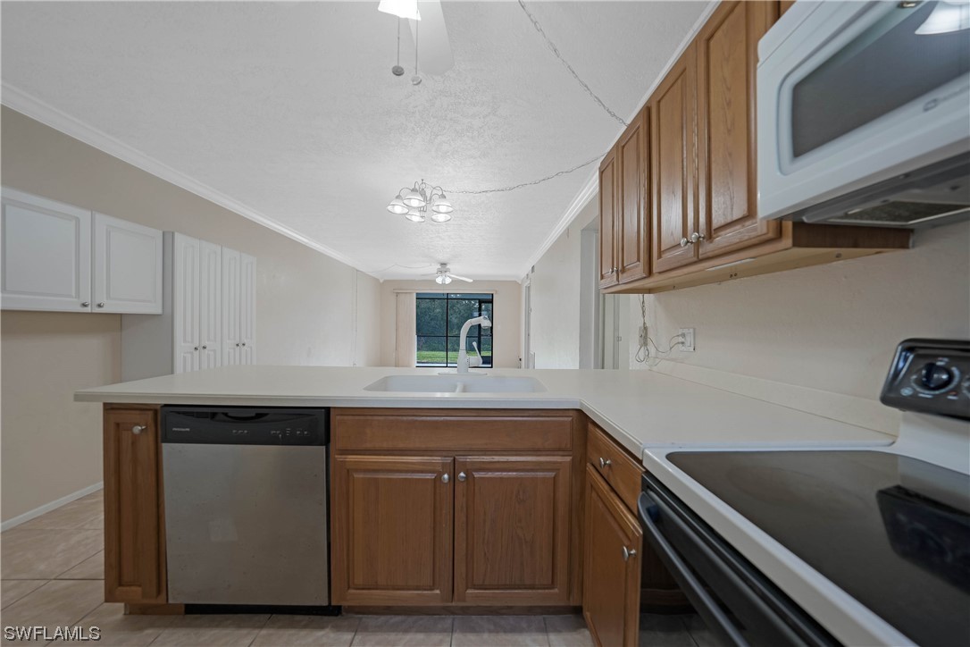 26485 Rampart Boulevard, Unit A6 Punta Gorda, FL 33983 - Photo 10 of 32 a kitchen with a sink and cabinets