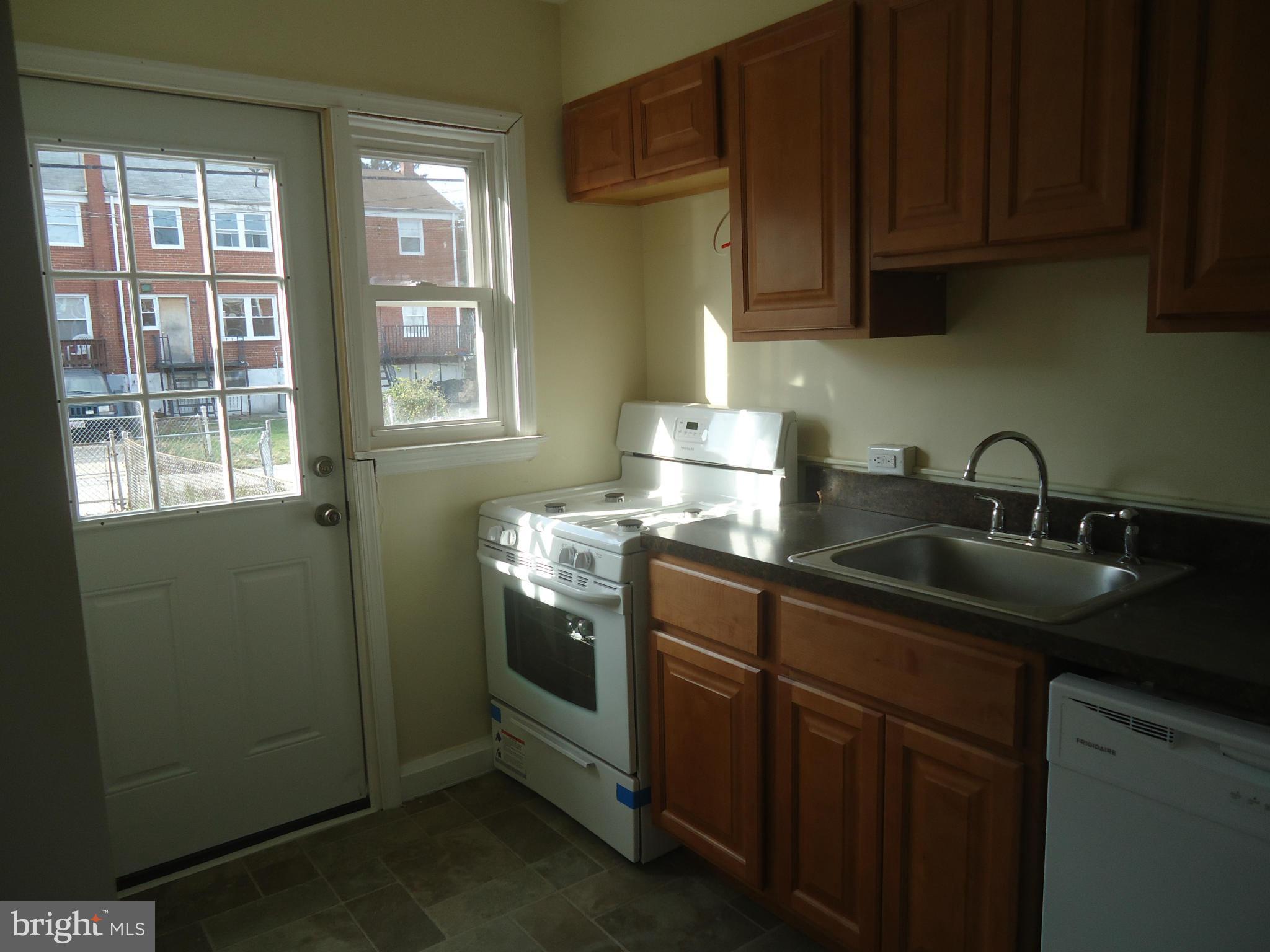 335 Torner Road Essex, MD 21221 - Photo 12 of 14 a kitchen with sink cabinets and window