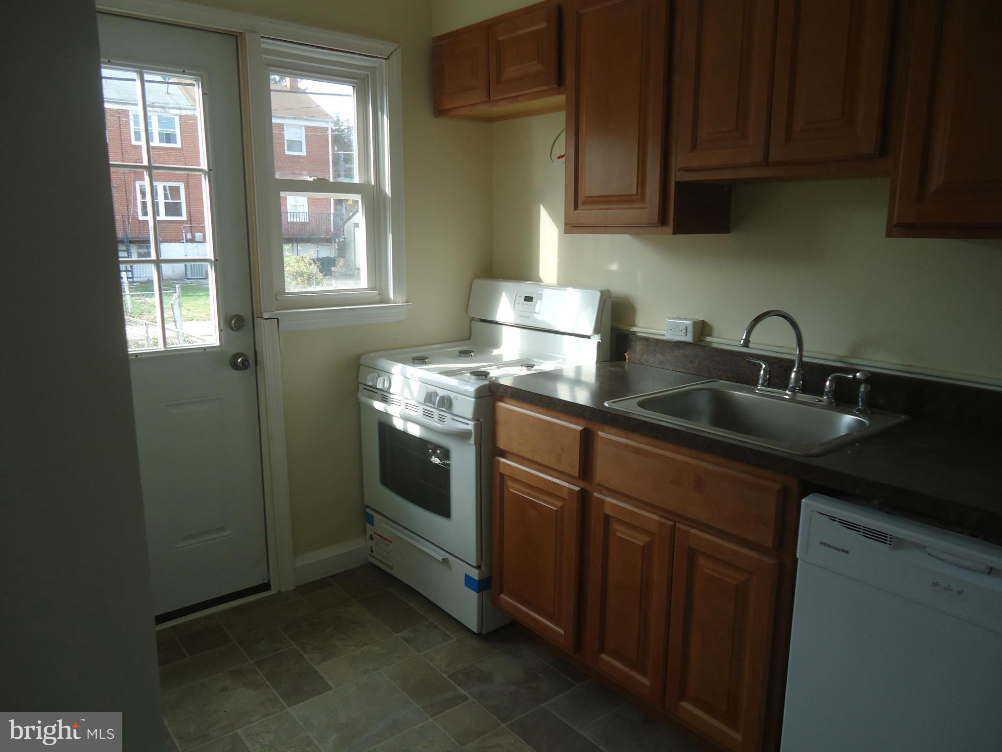 335 Torner Road Essex, MD 21221 - Photo 13 of 14 a kitchen with stainless steel appliances granite countertop a sink stove and cabinets