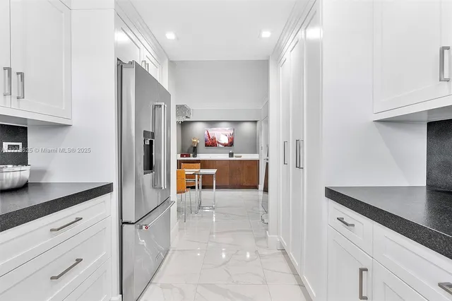 a kitchen with kitchen island cabinets and refrigerator
