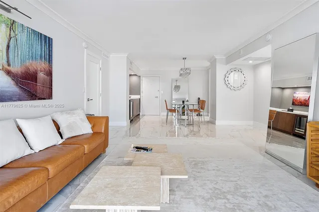 a living room with furniture and a dining table