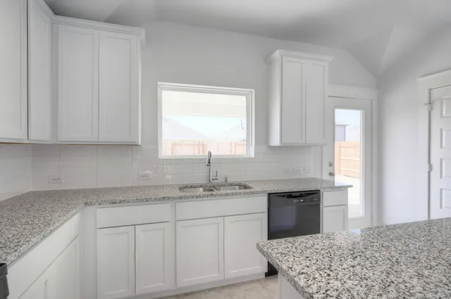 a kitchen with a sink cabinets and window