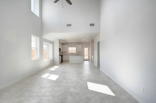 a view of a hallway with wooden floor and windows