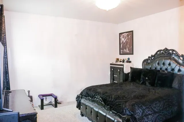 a bedroom with a bed and a table in it