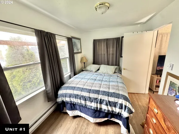 a bedroom with a bed next to a large window