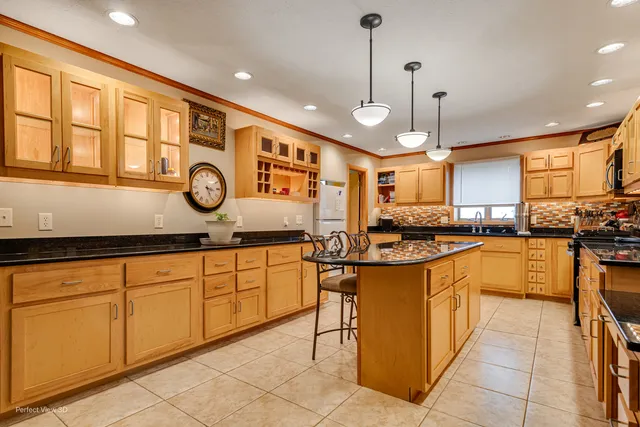 a kitchen with stainless steel appliances granite countertop sink stove top oven and cabinets