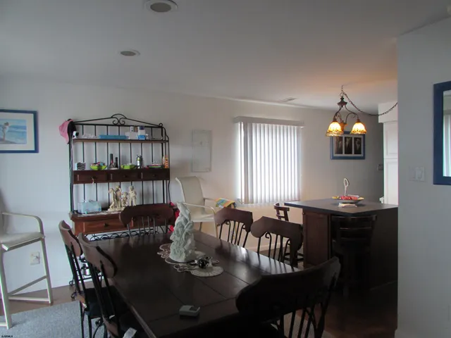 a view of a a dining room with furniture window and wooden floor