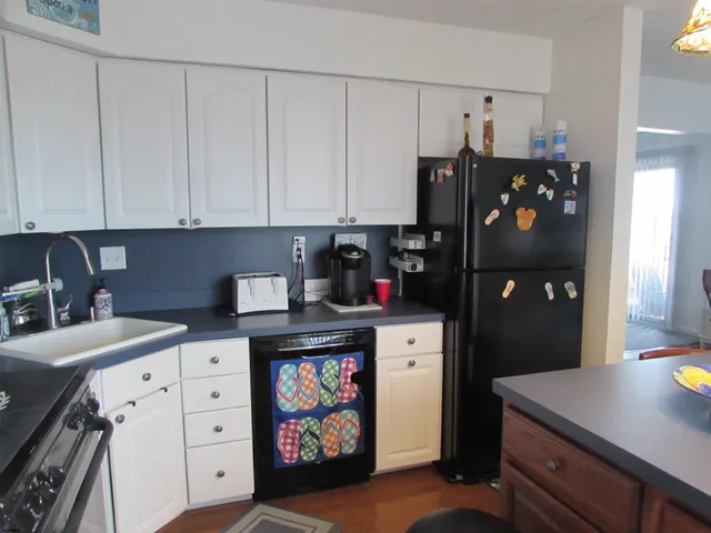 a kitchen with stainless steel appliances a stove refrigerator and cabinets
