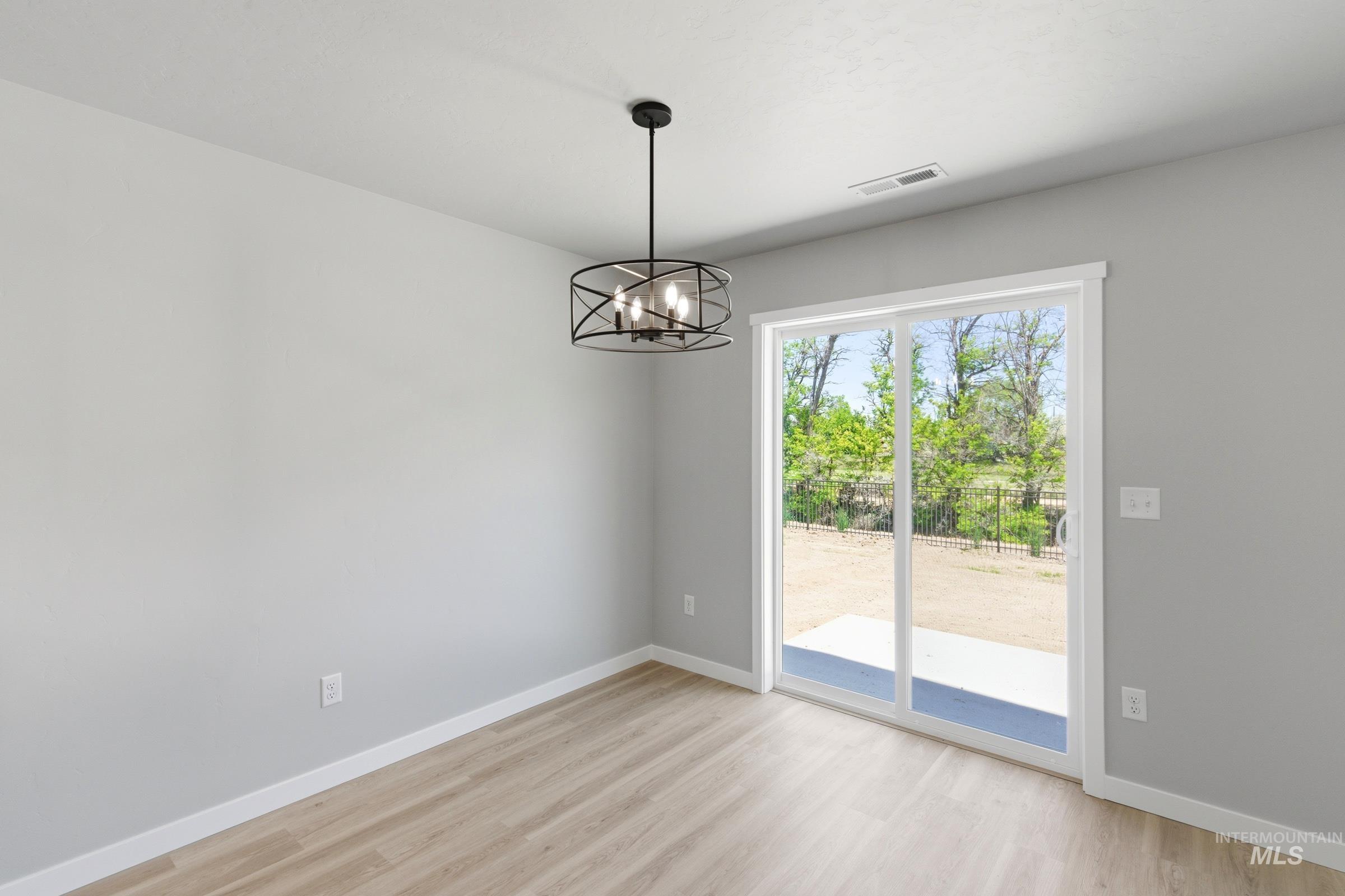 2374 West Fallon Loop Nampa, ID 83651 - Photo 7 of 24 Room featuring wood-finish flooring, light gray walls, and white trim
