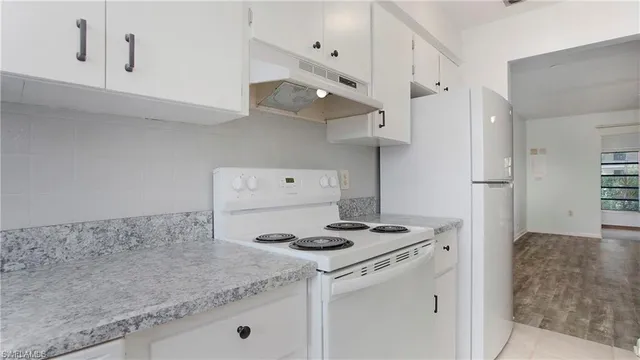 a view of hallway with wooden floor
