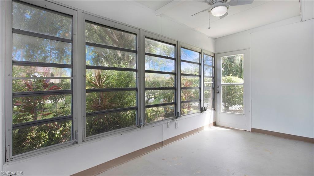 600 Valley Stream Drive, Unit I Naples, FL 34113 - Photo 3 of 20 Unfurnished sunroom with concrete floors and baseboards