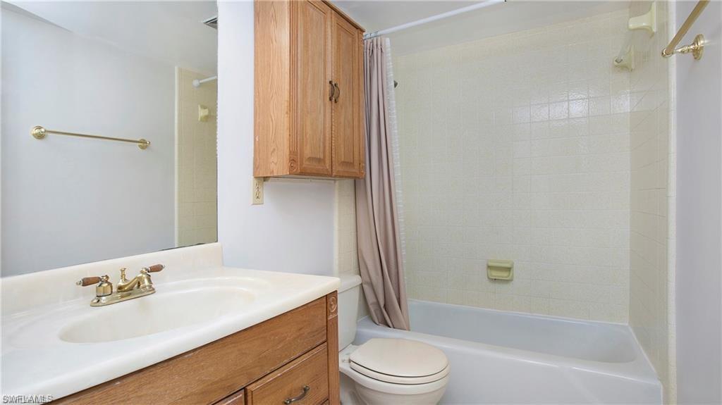 600 Valley Stream Drive, Unit I Naples, FL 34113 - Photo 6 of 20 Full bathroom featuring shower / bath combo and vanity