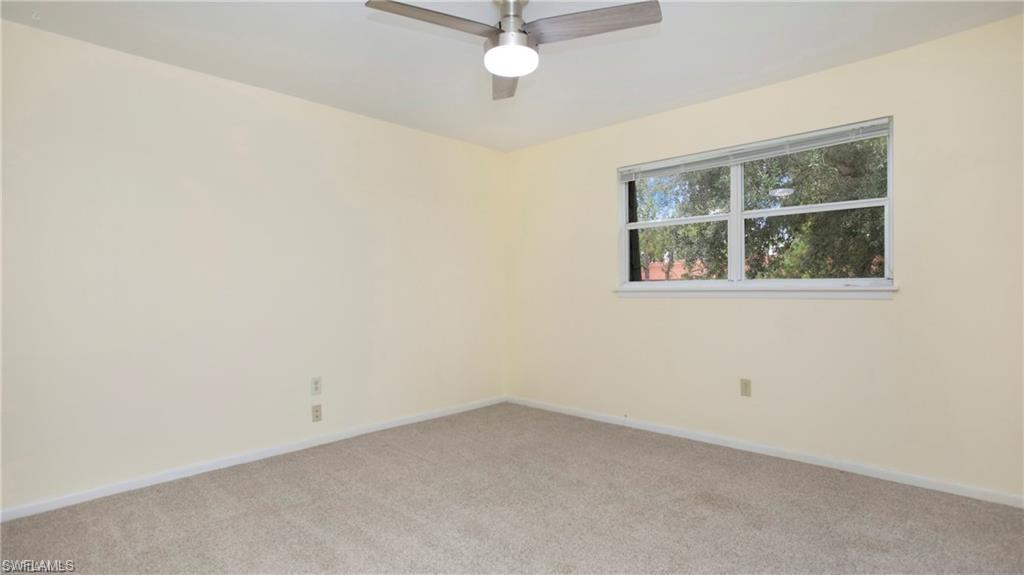 600 Valley Stream Drive, Unit I Naples, FL 34113 - Photo 8 of 20 Carpeted empty room featuring baseboards and a ceiling fan