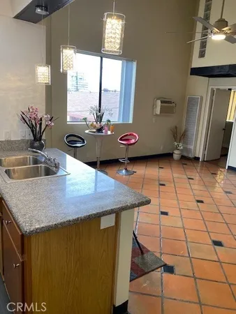 a kitchen with a sink a counter space and a window