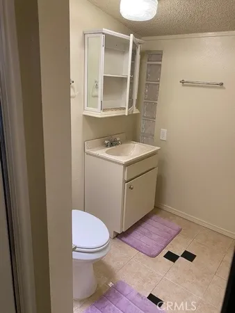 a bathroom with a sink toilet and mirror
