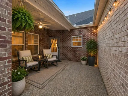 a view of a patio with couches and potted plants