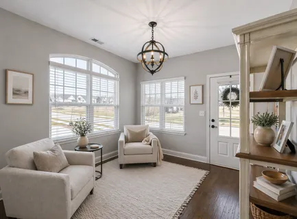a living room with furniture chess table and a window
