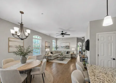 a view of a dining room with furniture wooden floor and chandelier
