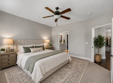 a bedroom with a bed and ceiling fan