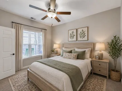 a bedroom with a large bed and a chandelier