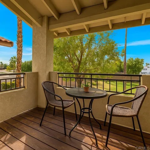a view of a chairs and table on the balcony