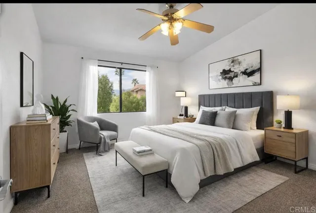 a bedroom with bed and a chandelier