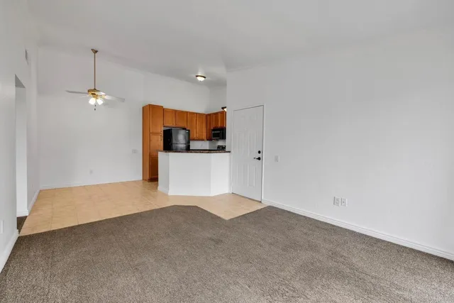 a kitchen with cabinets and wooden floor
