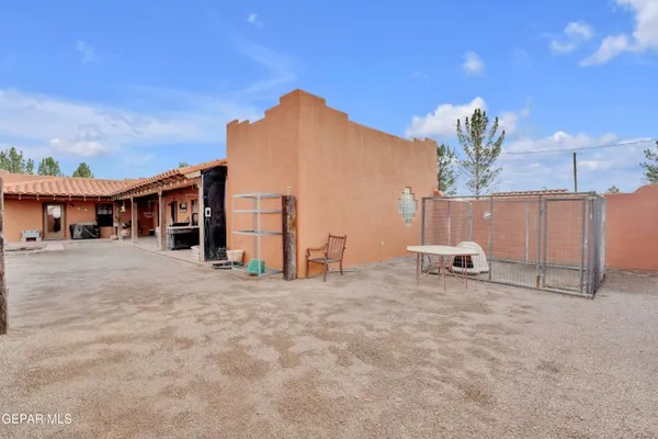 a view of a house with a patio and a yard