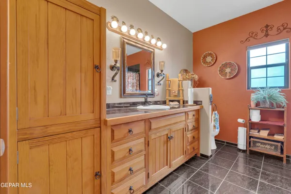 a bathroom with a sink a vanity and a mirror