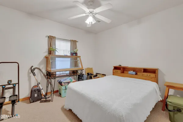 a bedroom with two beds and a chandelier