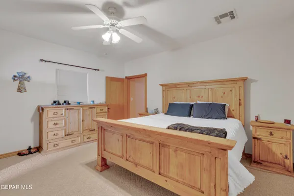 a bedroom with a bed and a dresser