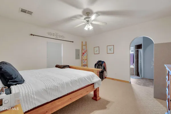a bedroom with a bed and a chandelier