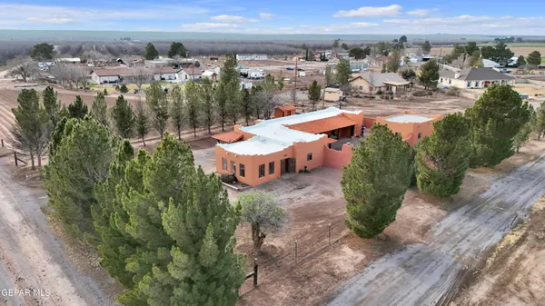 an aerial view of a house with garden space and outdoor seating