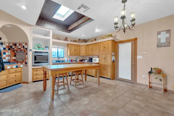 a room with stainless steel appliances kitchen island granite countertop furniture and a kitchen view