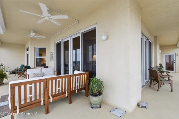 a view of a balcony with chairs