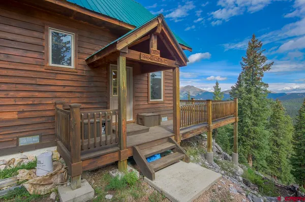 a balcony filled with furniture and floor to ceiling windows
