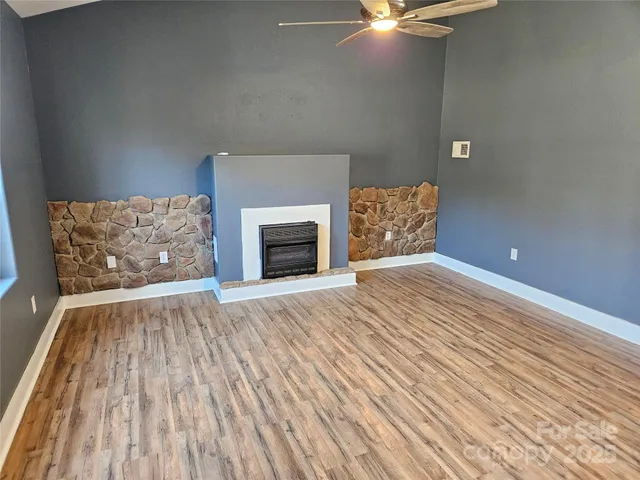 a view of an empty room and wooden floor