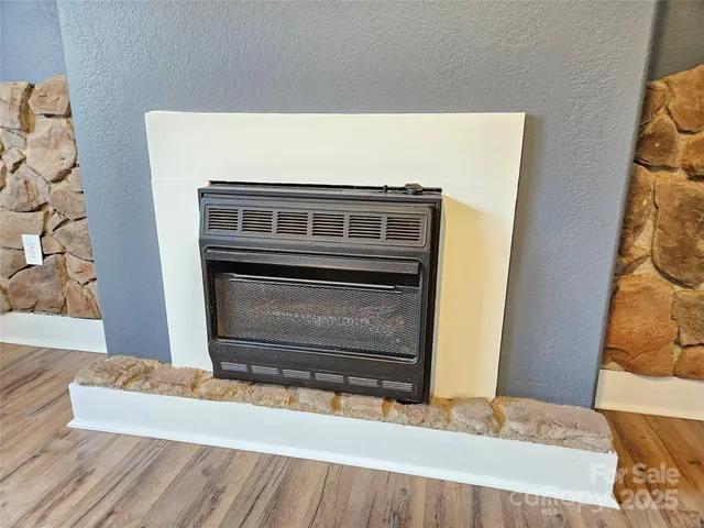 a living room with a fireplace furniture and a wooden floor