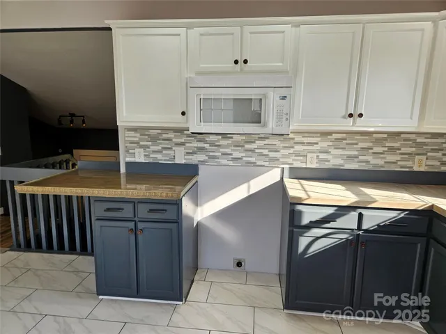 a kitchen with granite countertop a sink and cabinets