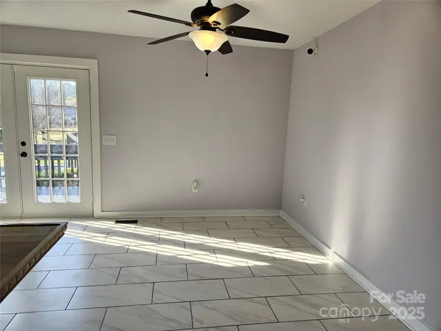 a view of an empty room with a window