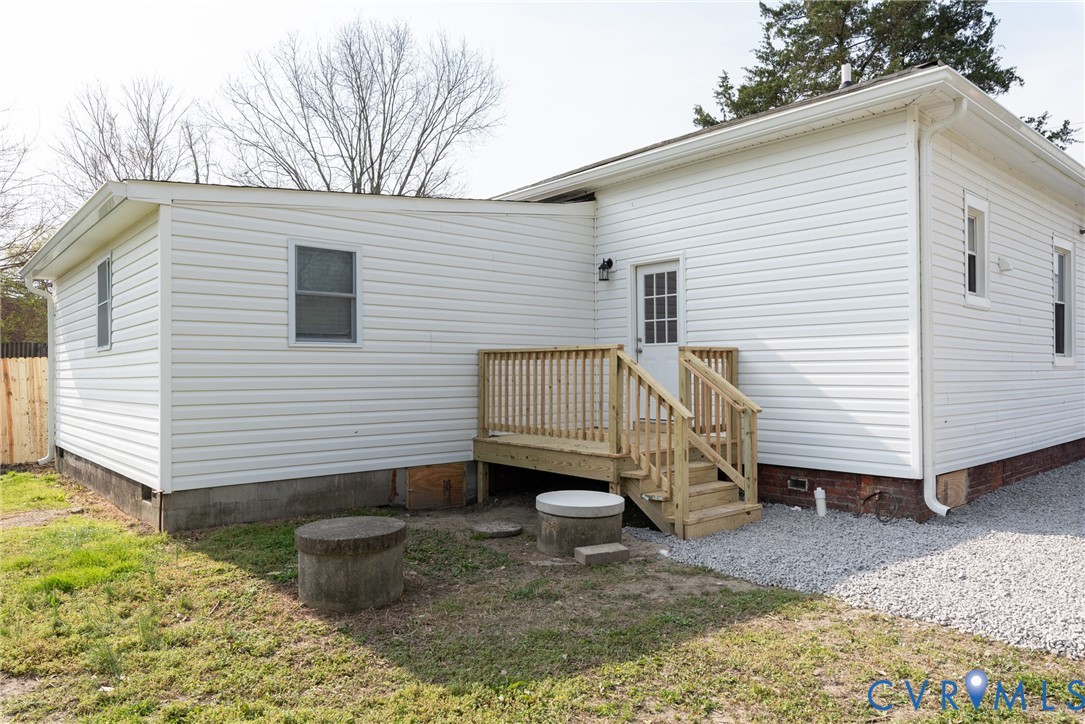 9800 Golf Course Drive Disputanta, VA 23842 - Photo 18 of 19 a view of a small house with a yard and wooden fence