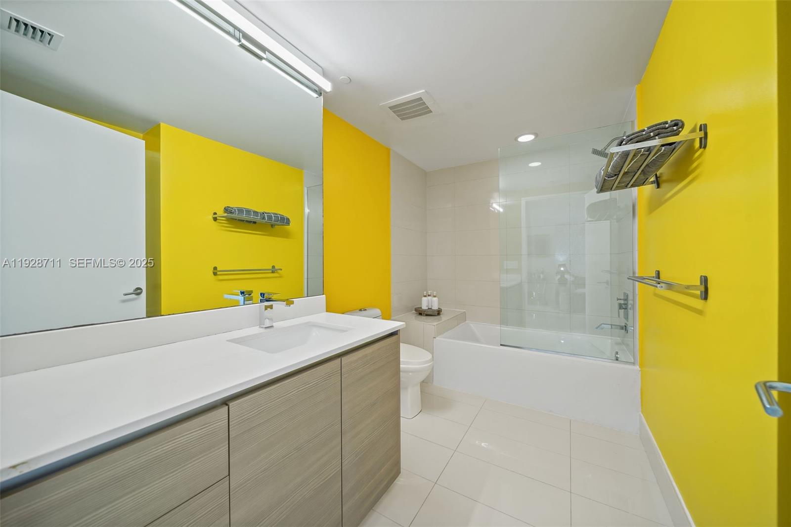 460 Northeast 28th Street, Unit 3904 Miami, FL 33137 - Photo 24 of 54 a bathroom with a sink a tub and a shower