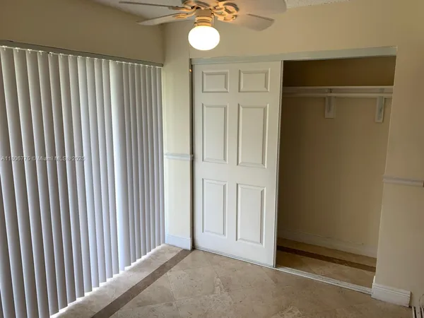 a view of a livingroom with a chandelier fan
