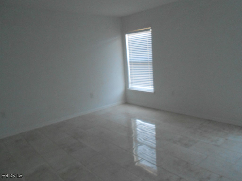154 Shadowview Court Lehigh Acres, FL 33974 - Photo 13 of 40 an empty room with windows