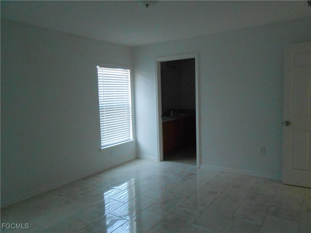 154 Shadowview Court Lehigh Acres, FL 33974 - Photo 14 of 40 a view of an empty room with a window