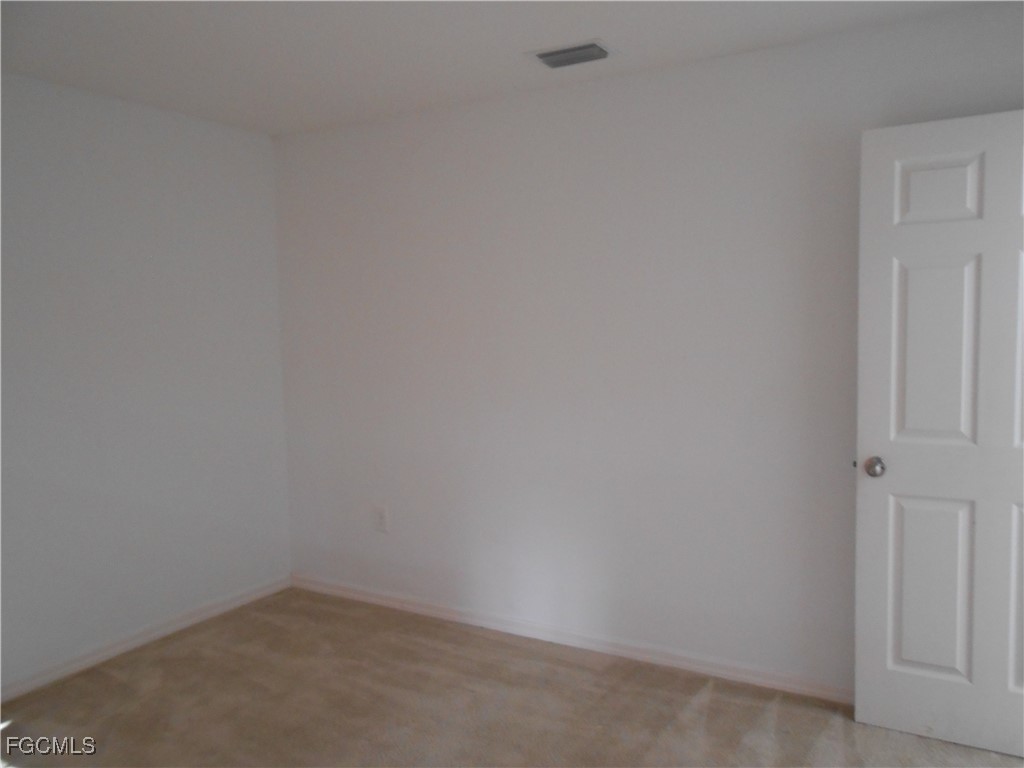 154 Shadowview Court Lehigh Acres, FL 33974 - Photo 15 of 40 a room that has a white wall