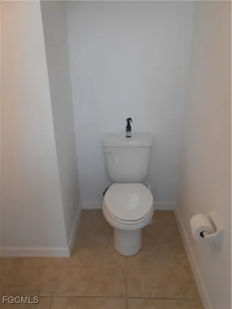 a white toilet sitting in a bathroom