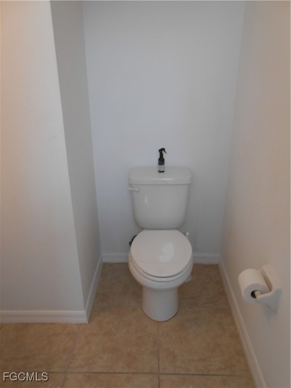 154 Shadowview Court Lehigh Acres, FL 33974 - Photo 18 of 40 a white toilet sitting in a bathroom