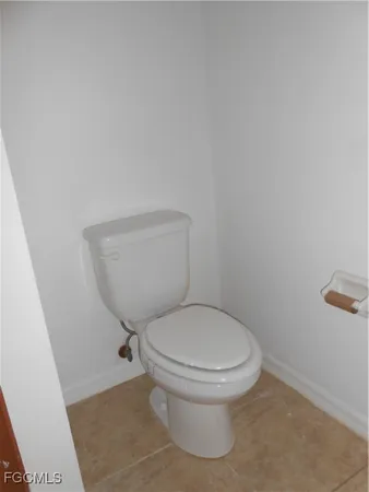 a white toilet sitting next to a white cabinet