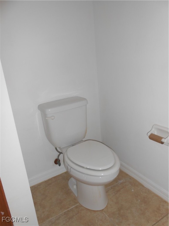 154 Shadowview Court Lehigh Acres, FL 33974 - Photo 23 of 40 a white toilet sitting next to a white cabinet
